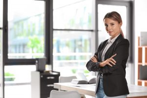 Portrait of female business trainer in office wear at workplace