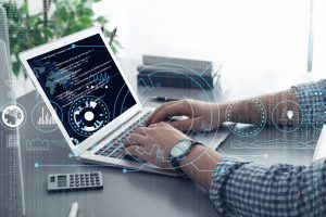 Professional programmer working with laptop in office